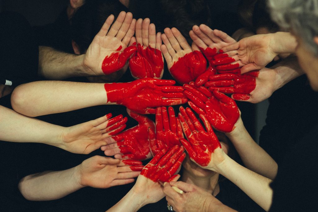 Many hands grouped together to form a heart